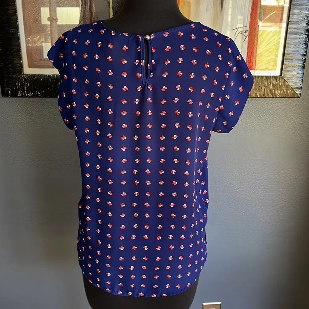 Lily White navy tiny heart flowers pattern X neckline top. Medium.